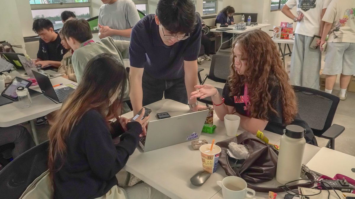 Participants collaborating around a laptop